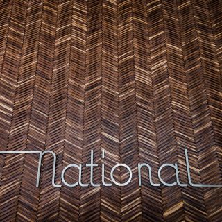 Interior sign at The National, with wooden herringbone design